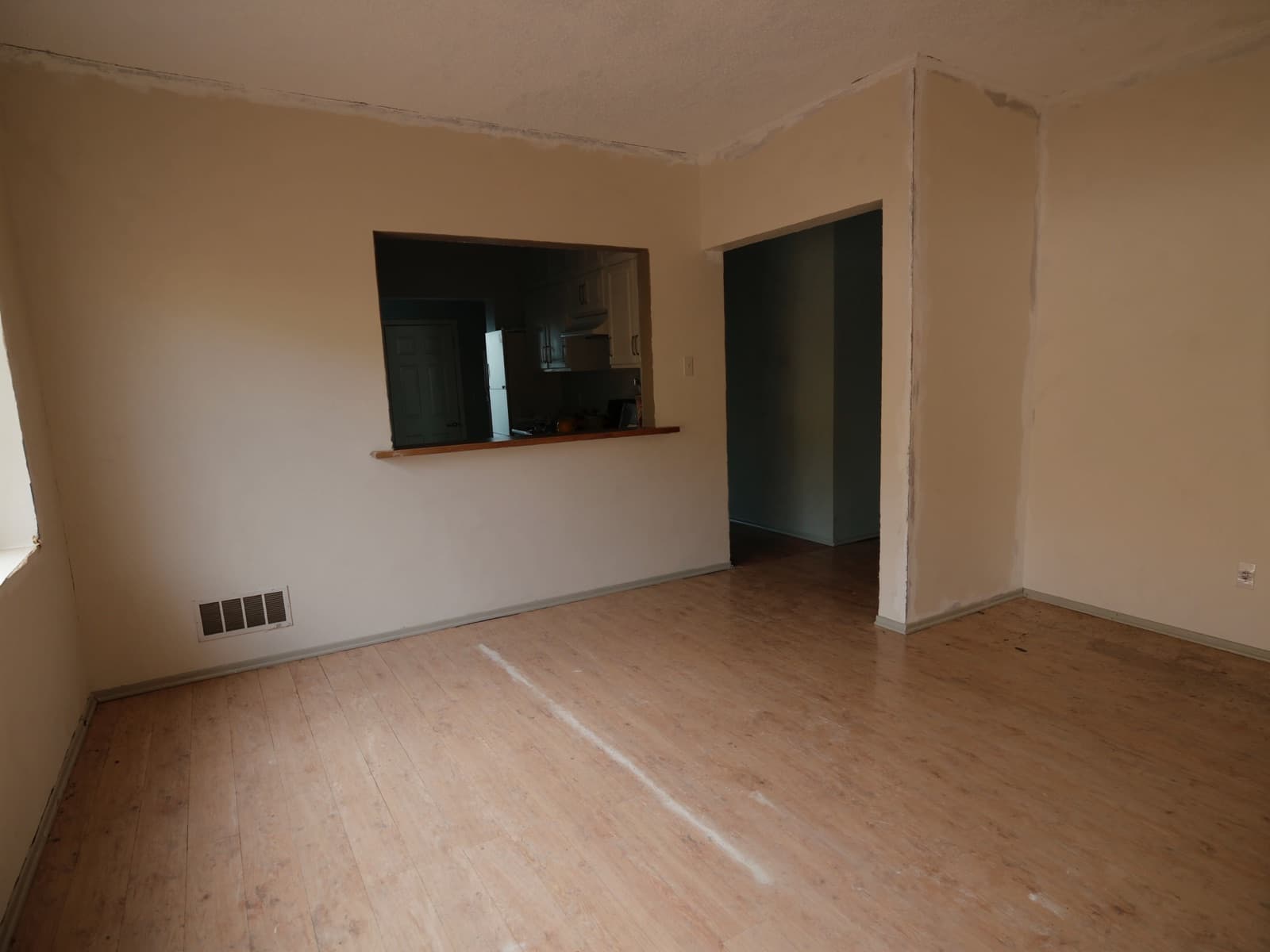 Dining area with dated peeling laminate flooring