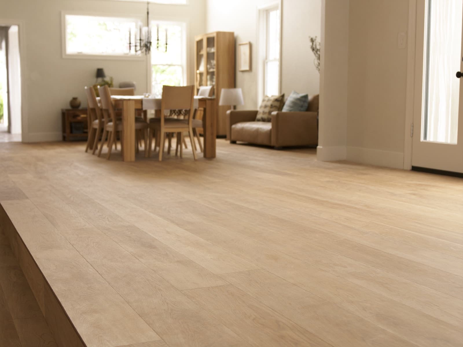 Open living and dining room with wide plank hardwood flooring